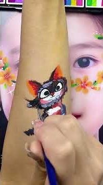 Cutest little chaos ball 🐾🖤This fluffy cat face paint is all attitude and adorableness!