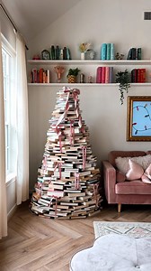 Michelle Hsu on Instagram: "Can you guess how many books this book tree took? I almost gave up because I couldn’t get the shape right and I was running out of books! But it turned out so magical🥹 #christmasdecor book lover bookshelf book tree living room decor Christmas decorating living room inspo bookish cozy home #myhomevibe #livingroomdecor #beforeandafter #christmasdecorations #christmastree Christmas tree"