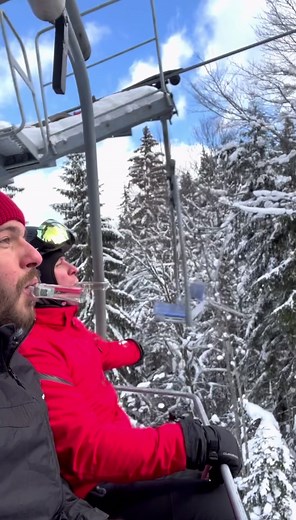 Enjoying a Scenic Ski Lift Ride in Winter Gear