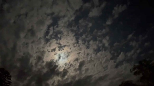 Moon peeking through clouds in Gray, Kentucky, USA