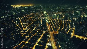 Slow motion illuminated night streets at Manila metropolis aerial view. Epic illuminated skyscrapers and highway. Philippines city with modern buildings. Cinematic architecture scenic at dark twilight