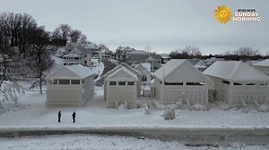 Drone footage showed a row of houses fully crystallized in ice, turning Ontario's Fort Erie town into a fairytale 'ice town' on Tuesday. | CBS Sunday Morning