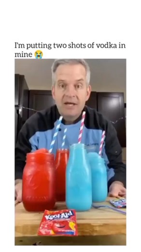Rider on Instagram: "The video showcases a detailed process of making homemade Kool-Aid slushies, with a focus on the preparation and taste-testing of the drinks. The scene begins with a man standing behind a wooden table, where he has set up two mason jars filled with red slushies, one jar containing blue liquid, and another empty jar. Beside these, two boxes labeled "Kool-Aid" are placed, indicating the ingredients he will be using. The man starts by pouring one and a half cups of cold water i