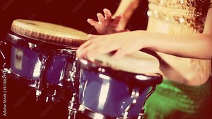 female percussion drummer performing with bongos