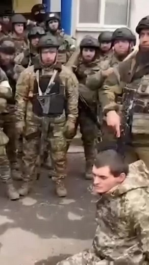 Russian National guard with a captured Ukrainian soldier #ukrainewar #mariupol