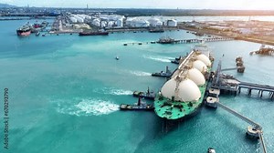 LNG (Liquefied natural gas) tanker anchored in Gas terminal gas tanks for storage. Oil Crude Gas Tanker Ship. LPG at Tanker Bay Petroleum Chemical or Methane freighter export import transportation