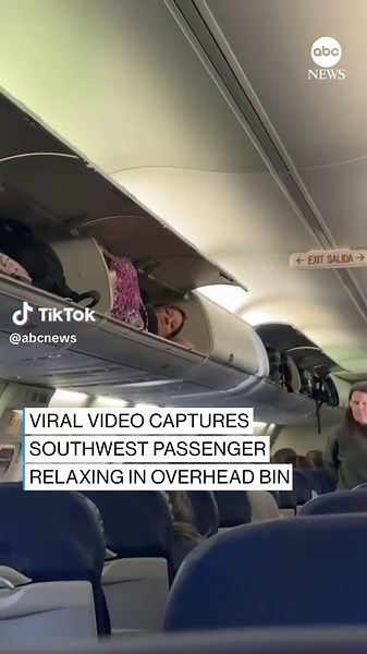 Footage captured by a Southwest Airlines passenger shows a woman curled up inside an overheard bin before a flight from Albuquerque to Phoenix. The passenger who shot the video says a flight attendant found her before take-off.