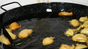 Frying Pettole - Typical dish of South of Italy. Pettole is a traditional christmas south italian food cooked from dough and fried in olive oil, made in Salento, Puglia