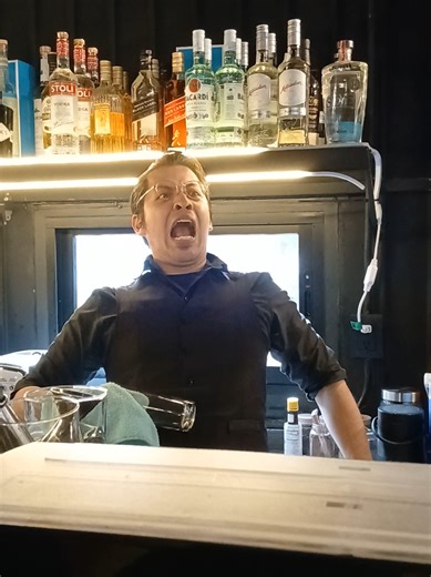 Humorous Bartender Struggles with a Big Crowd