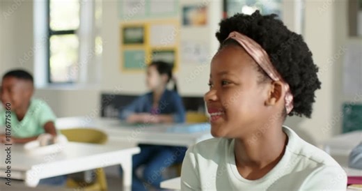 Classmates in class African American girl turning toward offscreen teacher prompt tablet headphones
