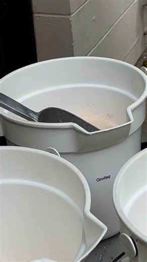 Putting the clay ingredients together. The plasticizer and the aged slip are already in. This is adding about a quarter of the kaolin, all of the feldspar, and all of the silica. The feldspar and silica have larger particles and they tend to clump together. The kaolin has very small particle size and so the idea here is for the kaolin to keep the feldspar and silica particles dispersed. All that is left is to add the rest of the kaolin. This batch will mix for two or three hours before that happ