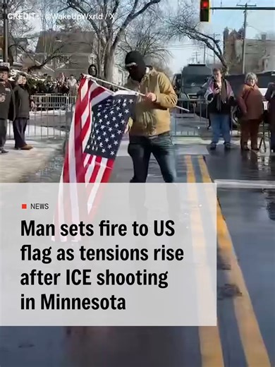 A man has been filmed setting fire to the US flag as tensions rise in Minnesota after an ICE agent shot a woman. Protests have taken place in Minneapolis after the fatal shooting of 37-year-old Renee Nicole Good by a US immigration agent. Videos of the incident show ICE agents approaching a car in the middle of the street. As it attempts to drive off, one of them points his gun at the driver, and at least two shots are heard. #US #trump #ICE #flag