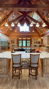 Wait for the transformation ✨😍 • 2 islands, see-through fireplaces, stone dining room, timber trusses, and this is just one part of the home! Watch the Forever Home tour on our YouTube channel 🎥 • If you’re looking to build a home like this, give us a call 1-800-270-5025 📱 🇺🇸🇨🇦 • #Mansion #estate #luxuryhomes #luxurylifestyle #luxuryrealestate #luxuryhome #mansions #mansionhouse #luxurymansion #rustic #customhomes | Golden Eagle Log & Timber Homes