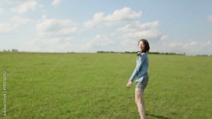 The girl runs barefoot through the field
