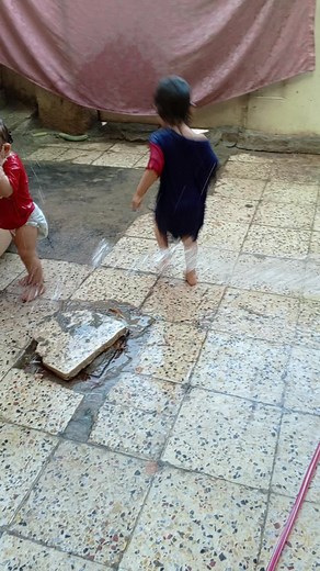 Children Playing and Splashing in Water Outdoors