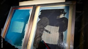 Cleaning plastisol ink from screen printing screens using chemicals and a scrubbing pad.