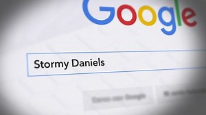 USA-Popular searches in 2018 Google Search Engine - Search For Stormy Daniels Monitor with reflection hands typing a search on google