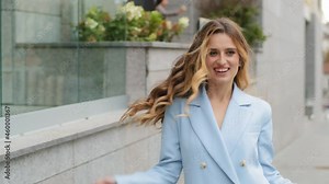 Happy active business woman motivated millennial caucasian stylish beautiful girl jumping dancing walking street in city spinning moving rhythm rejoicing winning celebrating dance movement outside