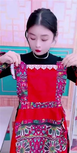 Beautiful chef in vibrant red traditional apron cooking in a stylish kitchen#viral #trending #chef
