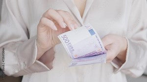 Euro Counting Precision: Woman Tallying 500 Euro Bills in Close-Up Video