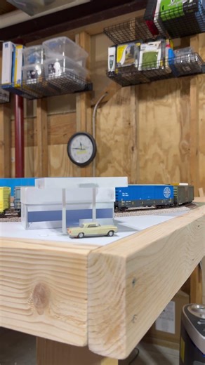LIRC Local takes a string of boxcars past a gas station on my 4x8 #hoscale #trainlayout #modeltrains
