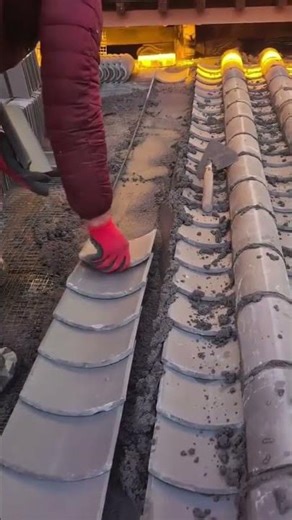 the process of installing flat roof tiles on cement mortar on the roof of a building #construction