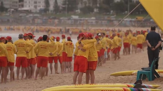 Surf lifesavers line up at Bondi Beach in a tribute to the victims of last Sunday's attack