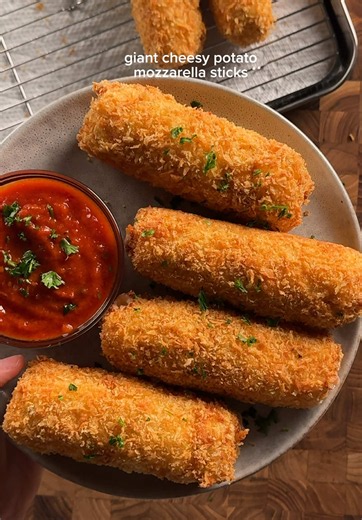 giant cheesy potato mozzarella sticks recipe! potato filling: 2 large russet potatoes 2 tbsp (30g) butter 1/4 cup (25g) fresh grated parm 1 egg yolk (optional but helps a lot w binding) salt and pepper 1 tbsp parsley chopped *boil the potatoes in salted water until theyre nice and soft, then mash until theyre all smooth. while warm, mix in the buter, parm, egg yolk, salt & pepper, and parsley. let cool a bit and the texture should be firm enough to hold its shape. note: i mixed the egg yolk and 