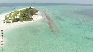 Aerial: Flying over idyllic atoll, travel destination Wakatobi National Park Indonesia Maldives Polynesia blue lagoon coral reef desert island white sand beach. Native cinelike D-log color profile