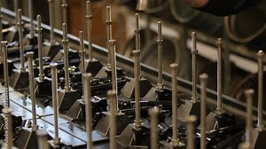 Worker putting together parts in an assembly line in shop