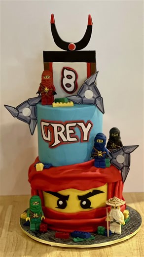 Cakeitecture Bakery on Instagram: "Slicing into adventure this Ninjago LEGO cake is almost too cool to eat! Complete with edible chocolate ninja warriors this cake will have you saying "Go Ninja go!"🥷🥷 #cakeitecture #happybirthday #BirthdayMagic #auburn #opelika #cakeitecturebakery #ninjago #lego #jackiechan #ninja #sculptedcake"