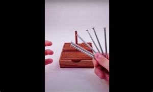 Learn how to balance 6 nails on top of a wooden dowel to wow your friends