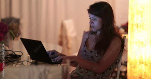 Woman working late night after work. Candid female worker from home