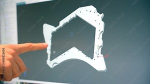 Engineers designing a metal piece in a computer