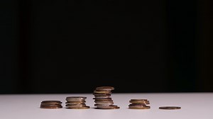 Stop motion animation Raising of coins stacks on Black background