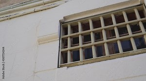 bars on the window of the prison cell, outside view