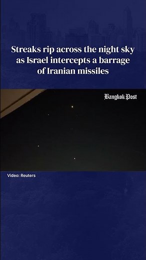 Streaks rip across the night sky as Israel intercepts a barrage of Iranian missiles