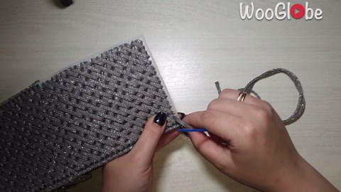 Artist creates a handmade bag using polyester cord and plastic canvas