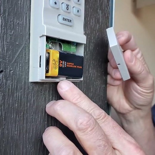 Removing Liftmaster garage door keypad battery cover.
