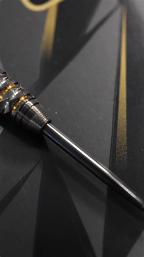 🚀 Our Greatest Ever Creation – Opus. The pinnacle of dart innovation, Opus is precision-milled 90% tungsten with new acute-facet cuts for ultimate grip and effortless release. Finished with a gun-metal titanium nitride coating and striking gold rings, Opus is more than a dart – it's a statement. Complete with a Slimcase, 2 sets of Carbon ST shafts, and 2 sets of Opus flights. Made in England. #HarrowsDarts | Harrows Darts