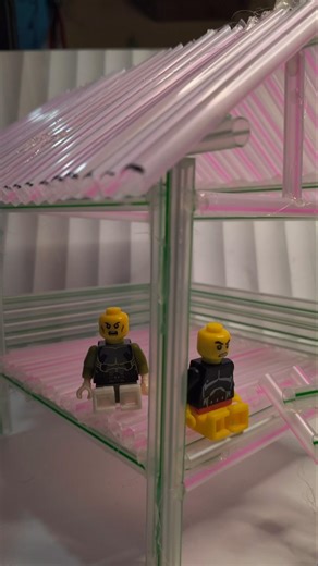 Stopmotion Lego minifigures taking shelter in a hut,