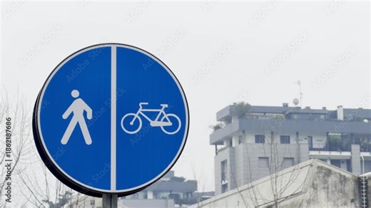 A blue traffic sign elegantly delineates a shared path for both pedestrians and cyclists, promoting safety and harmony within an urban setting.