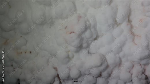 Close-up of natural salt formations inside a salt cave, showing mineral textures and crystalline surfaces. Geological detail of underground environment and natural deposits.