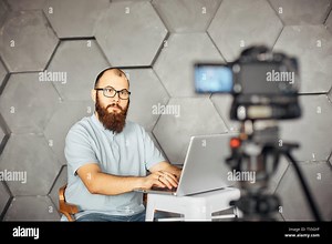 content creation for social media. bearded man shooting video of himself using camera on tripod. modern technology and blogging freelance work concept Stock Photo - Alamy