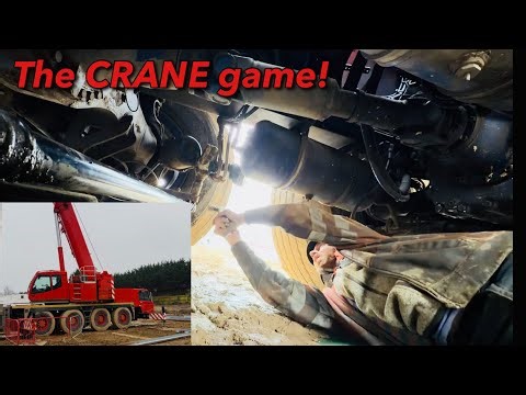 STRUGGLING around in MUD repairing a crane!