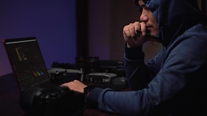 Download Asian creator editing production work in neon-lit office. for free