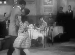 4.8K views · 189 reactions | 90 year old gold! Shorty George Snowden (3rd couple) from the first famous group of Lindy Hoppers representing the Savoy Ballroom to popularize the dance's beginnings on film! Here in in "After Seben".... Dig the fancy moves... even the dude in black face got it going on :>D Note on the bandstand in the back - Chick Webb! | The Harlem Swing Dance Society | Facebook