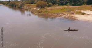 African fisherman in wooden canoe on the Kwanza River. Angola.