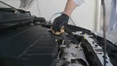 Car detailing service focusing on cleaning the engine compartment...