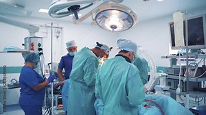 Operation room with specialists. Teamwork of surgeons performing operation on the background of modern equipment in private clinic.